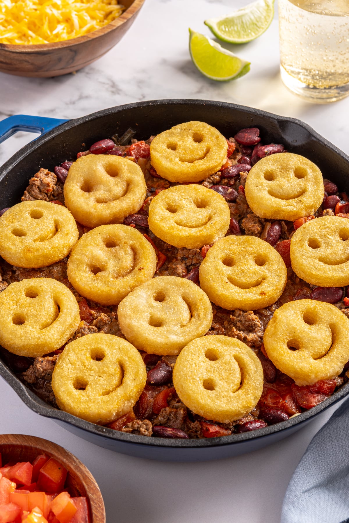 Skillet chili topped with french fry smiles.