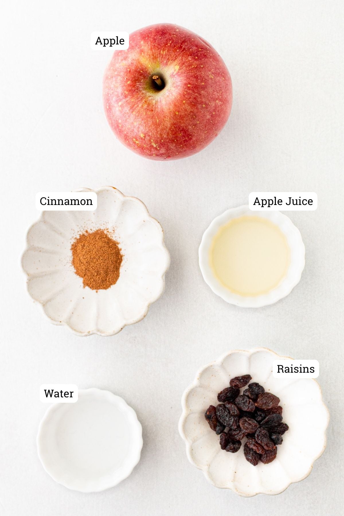 Ingredients needed for baked apples with cinnamon and raisins.