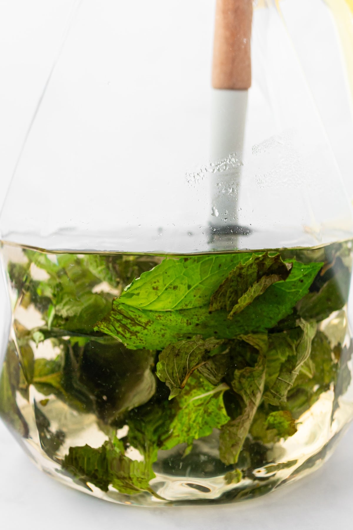 Stirring honey and lemon juice into mint tea.