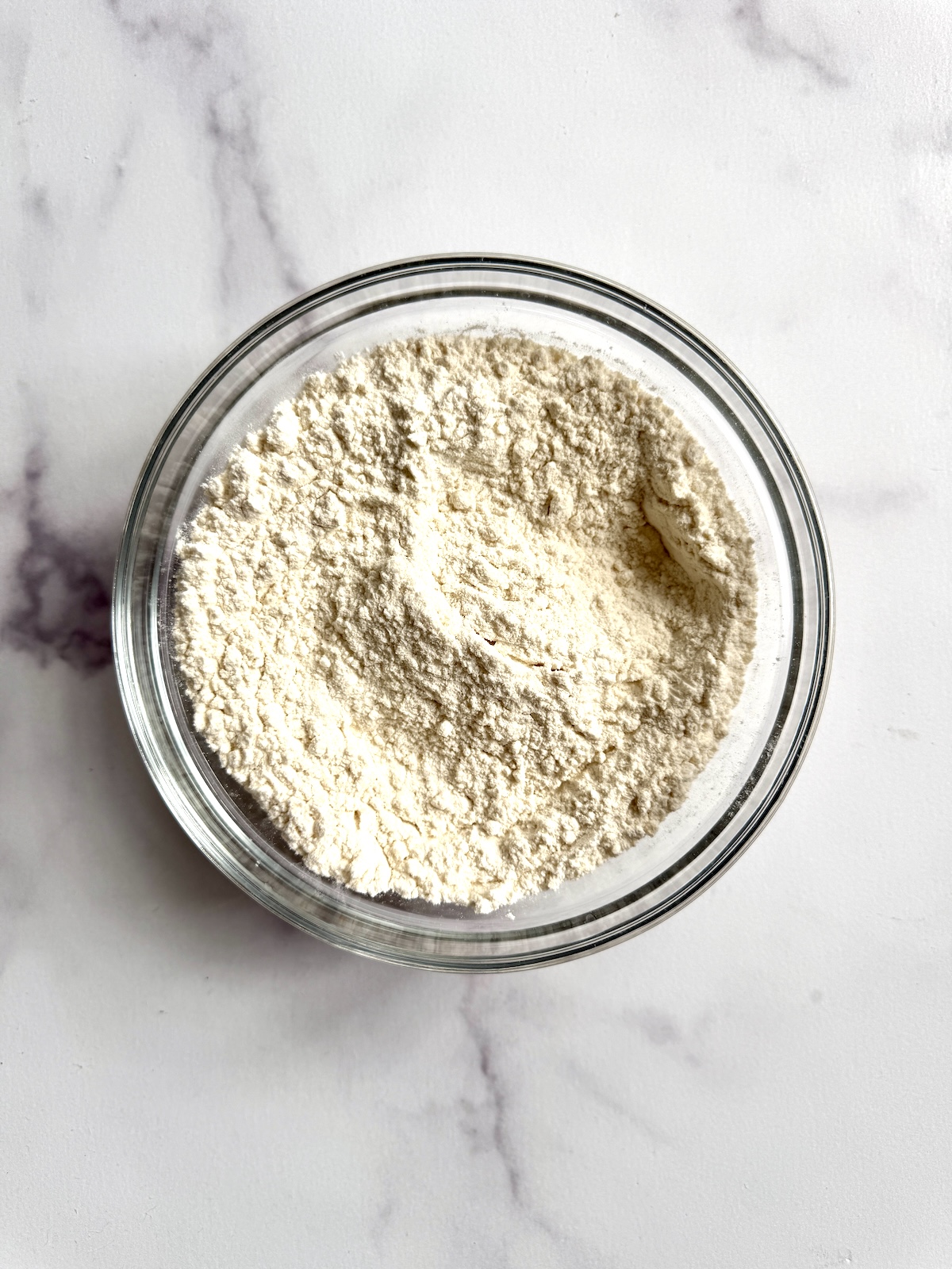 Dry ingredients for pumpkin cinnamon rolls in a bowl.