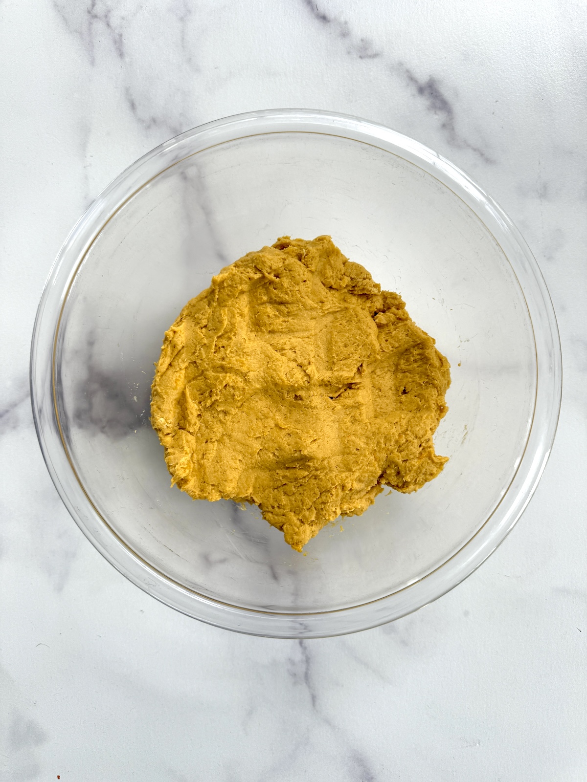 Quick pumpkin cinnamon rolls dough in a bowl.