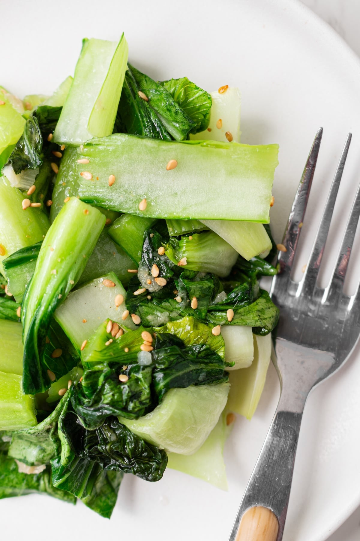 Sauteed baby bok choy on a serving plate.