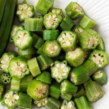 Pieces of steamed okra on a plate.