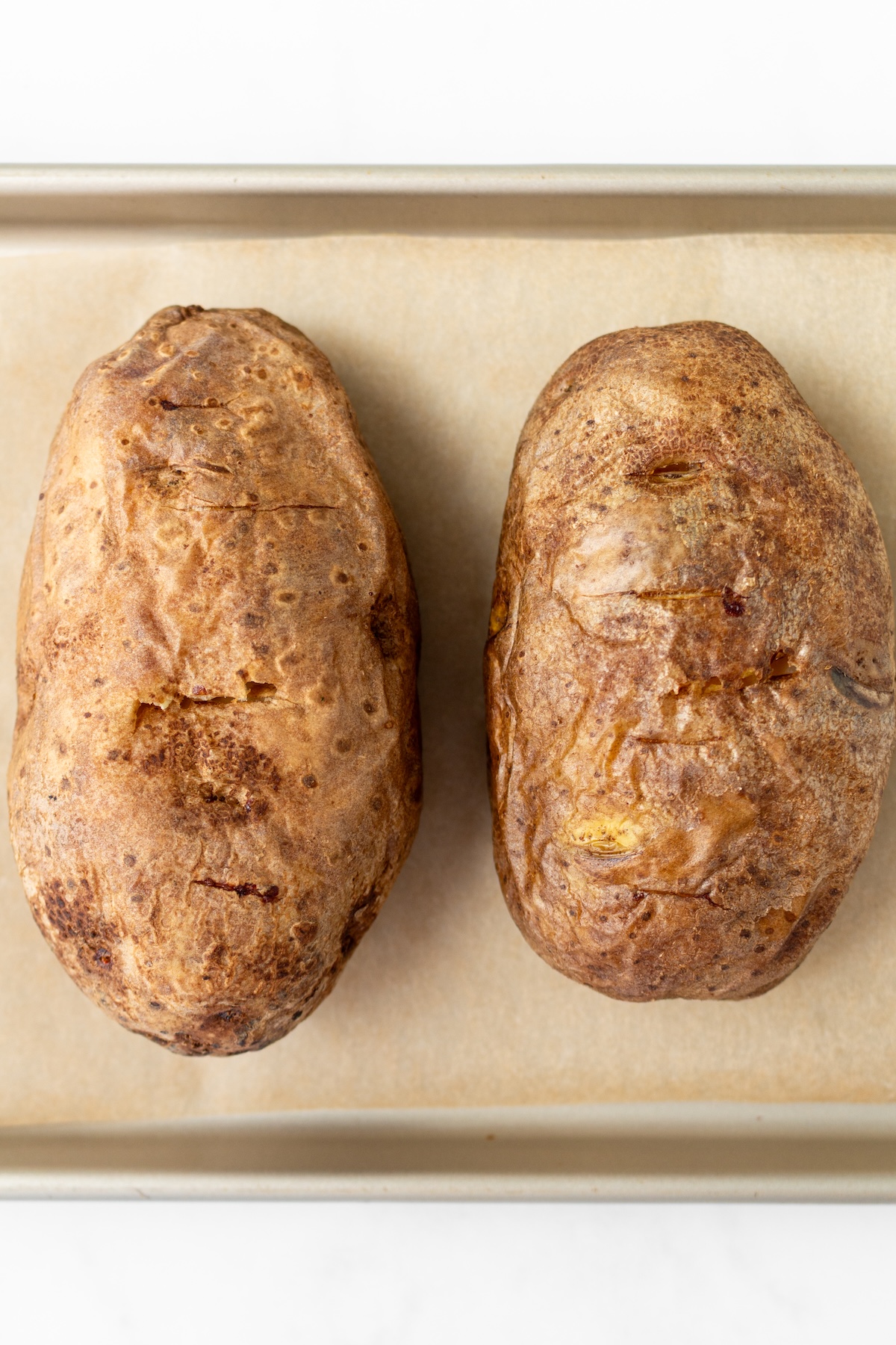 Baked potatoes on a baking sheet.
