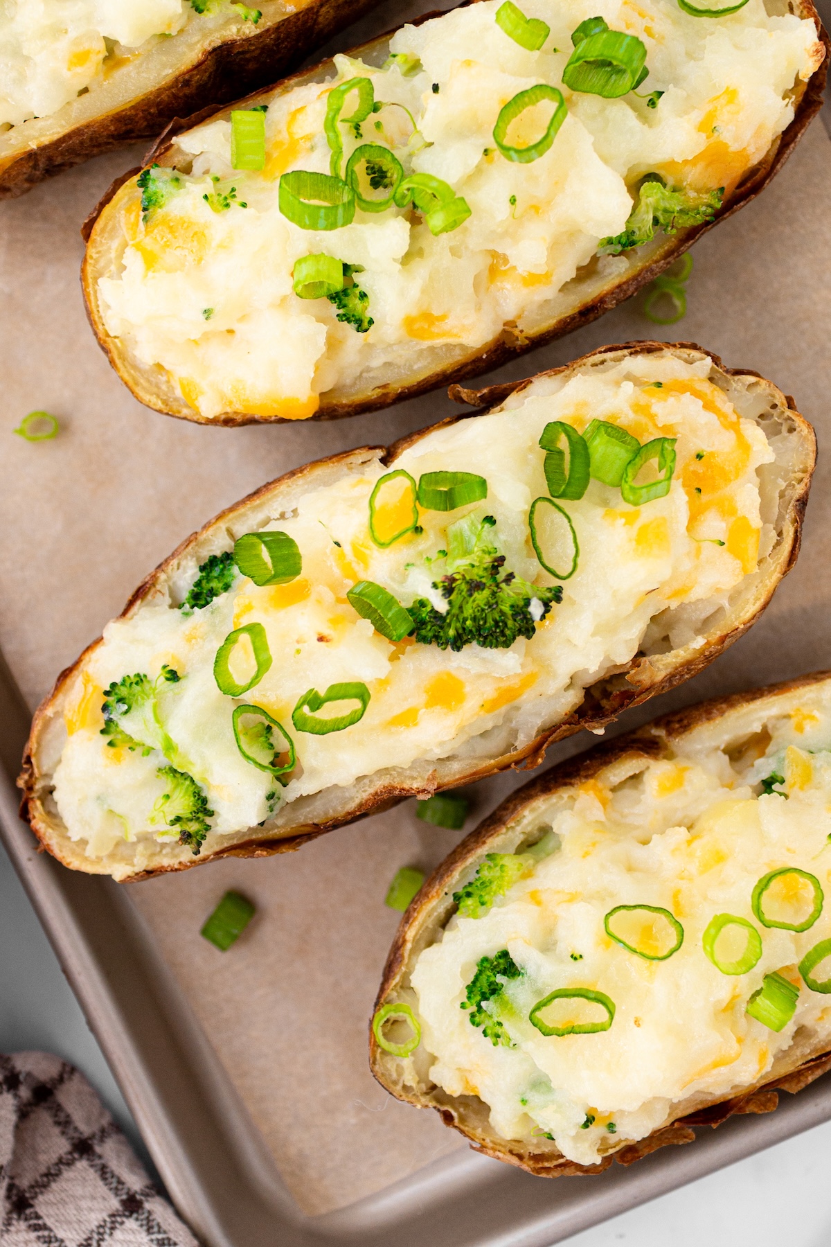 Twice baked potatoes on a baking sheet.