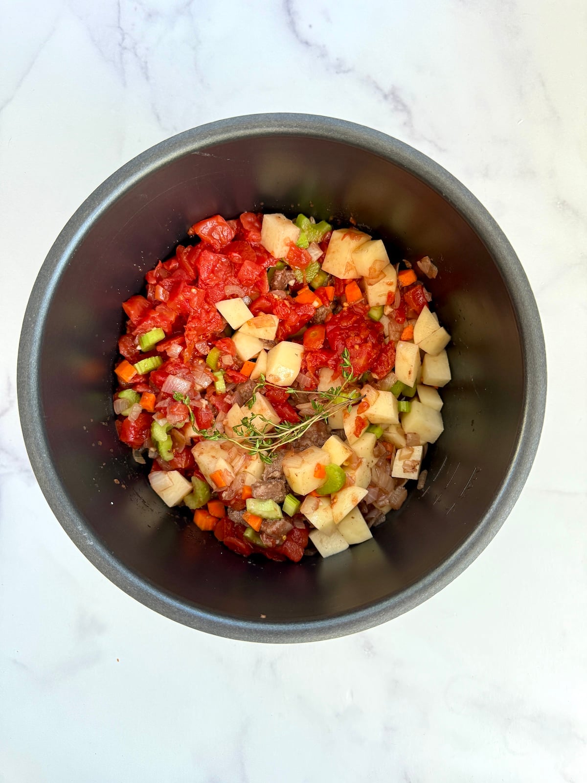 Beef stew ingredients in the crock pot.