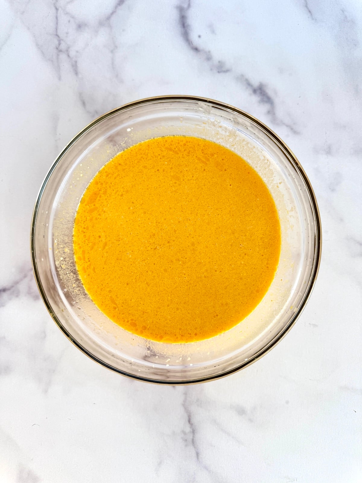 Pumpkin waffles wet ingredients in a bowl.