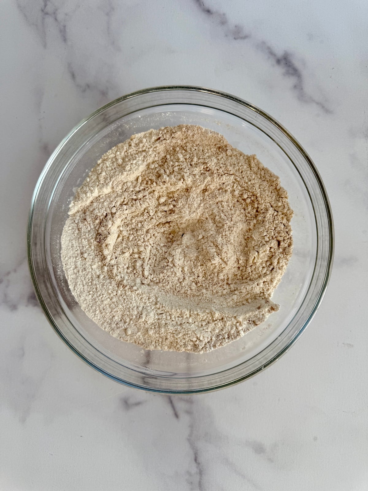 Dry ingredients for pumpkin waffles in a bowl.