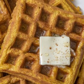 Pumpkin waffles topped with butter.