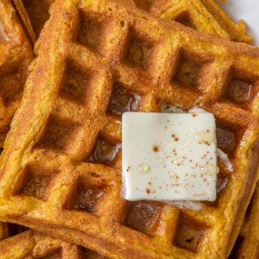 Pumpkin waffles topped with butter.