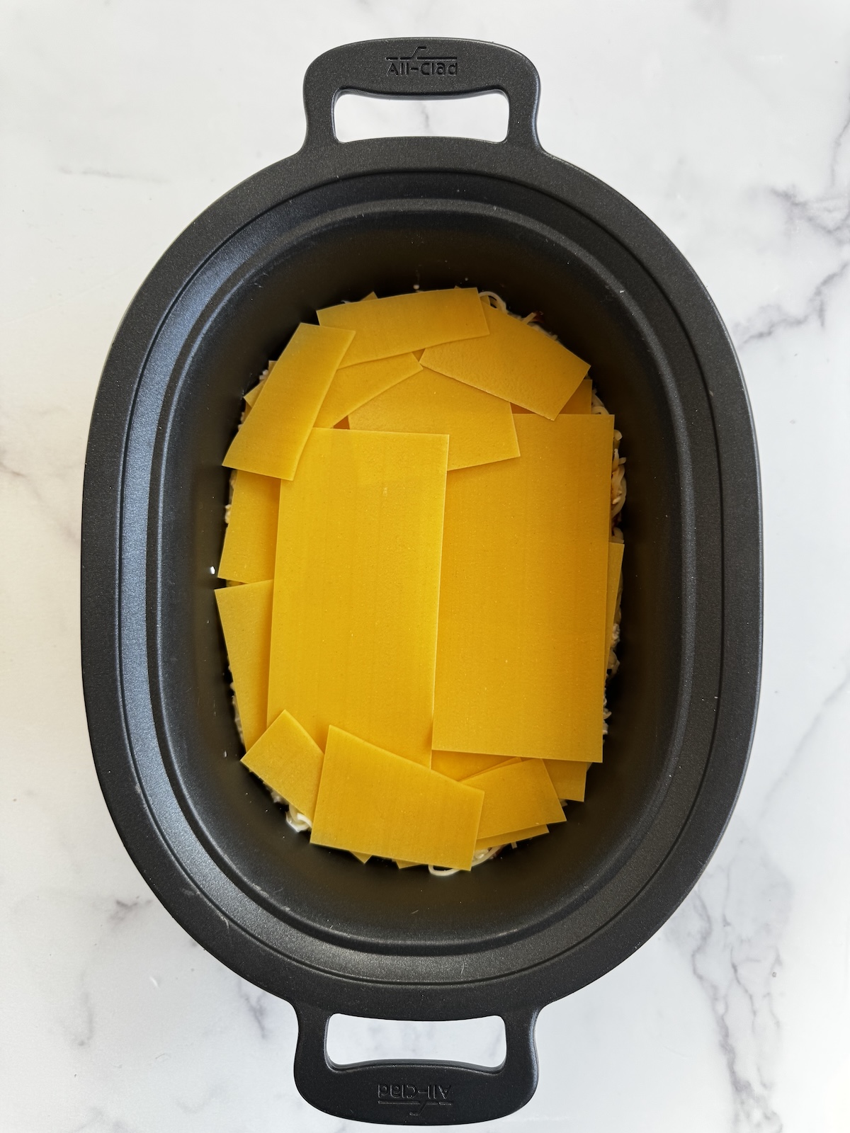 Layered lasagna in a slow cooker.