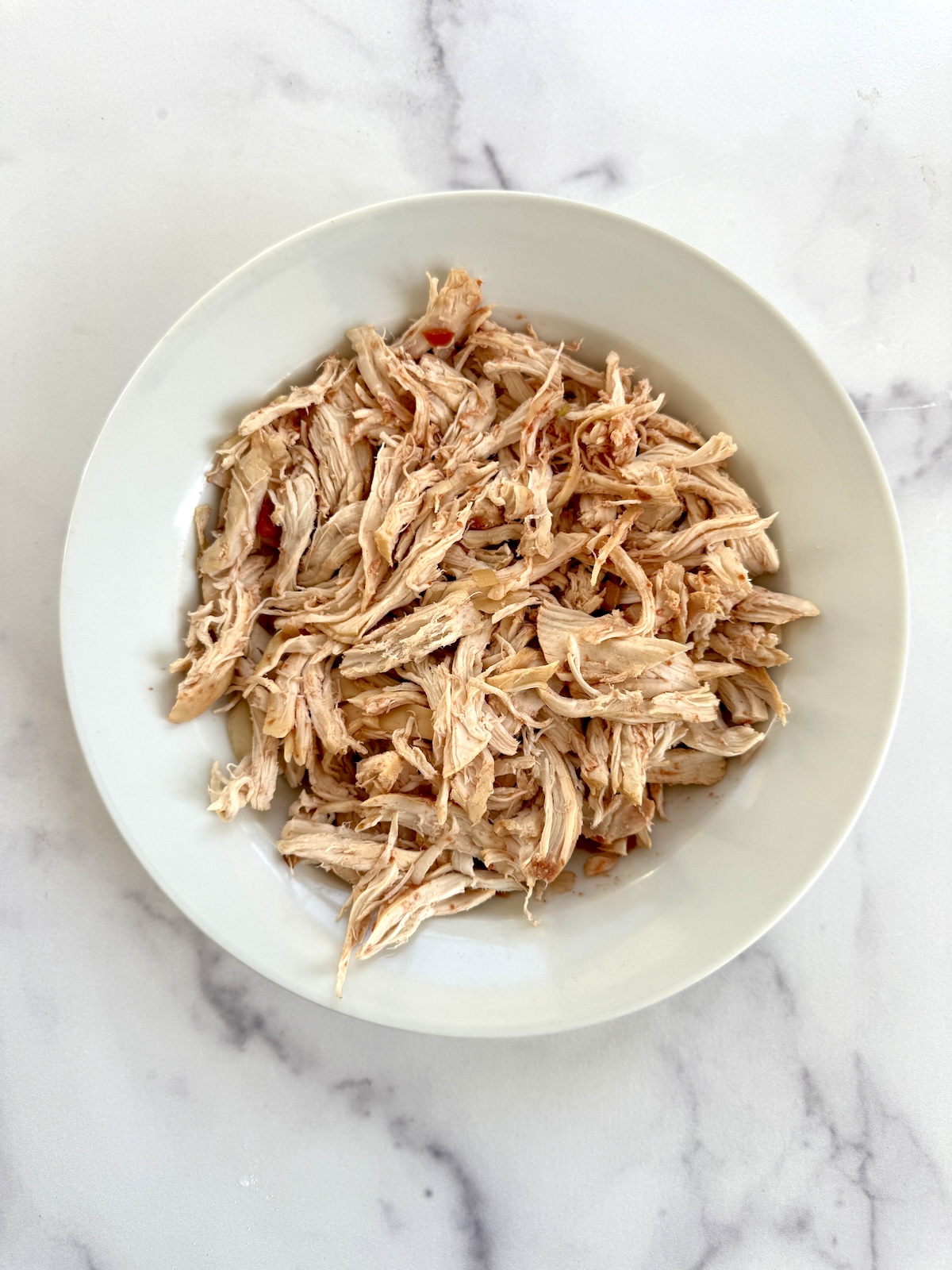 Shredded chicken in a bowl.