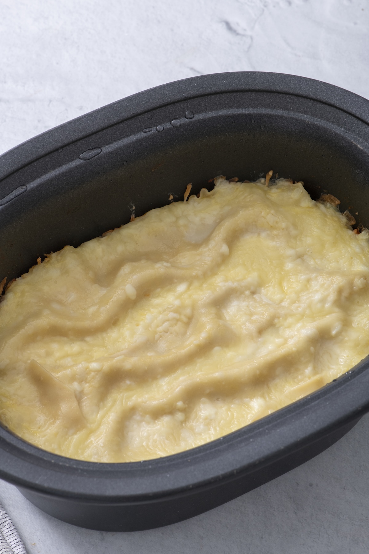 Cooked lasagna in a slow cooker.