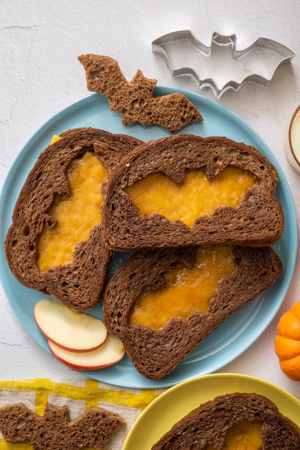 Grilled cheeses with bat- shaped cut outs for Halloween.
