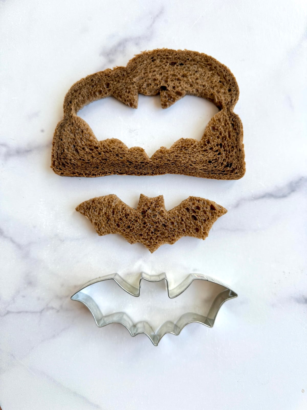Bat-shape cut out of piece of bread.