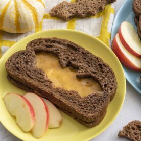 Spooky grilled cheese served with apple slices.