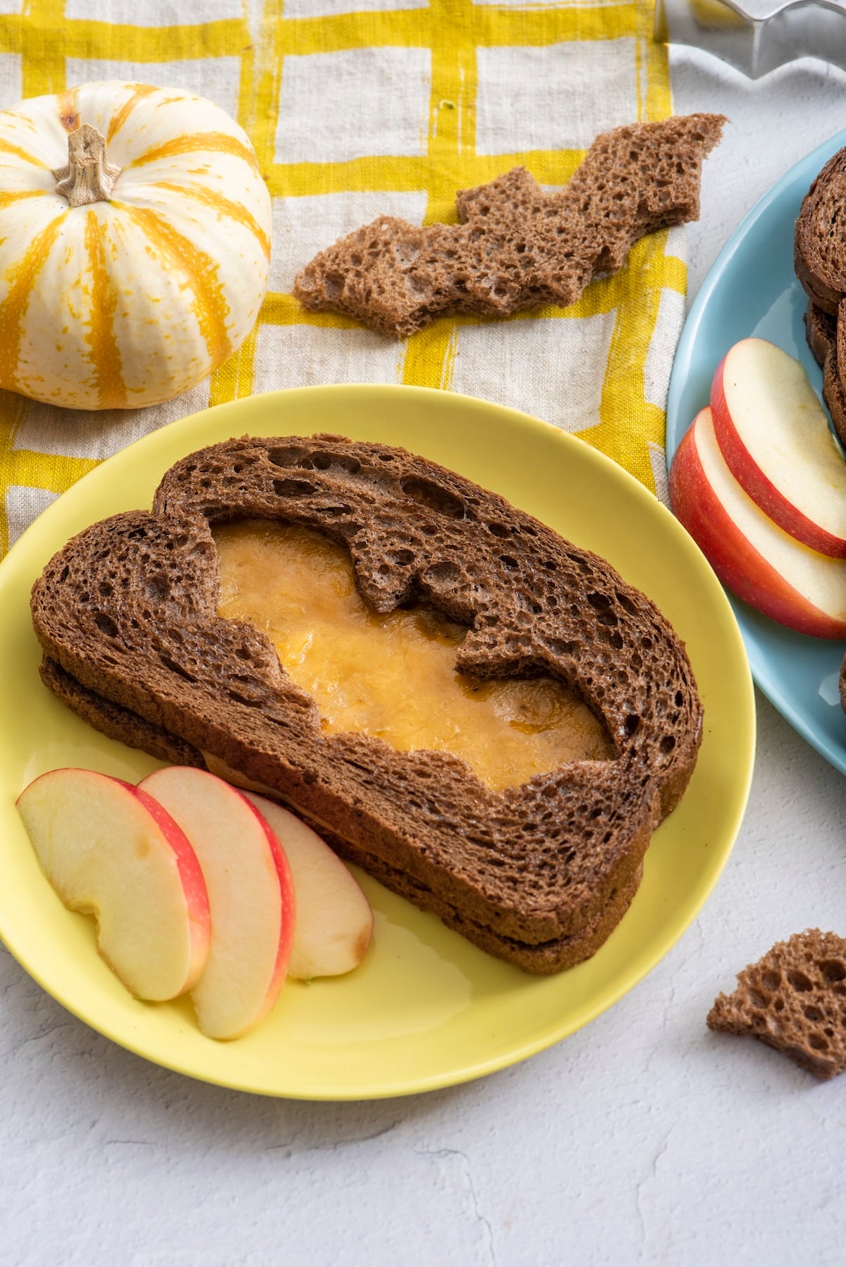 Spooky grilled cheese served with apple slices.