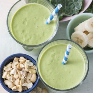 Two kale smoothies in glasses.