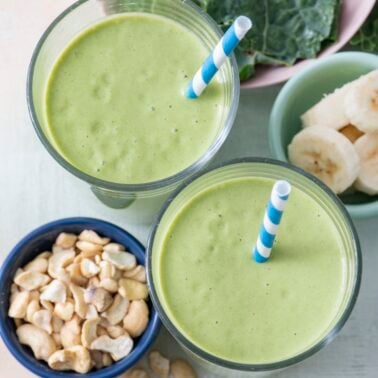 Two kale smoothies in glasses.