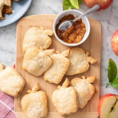 Apple pie turnovers on a serving board.