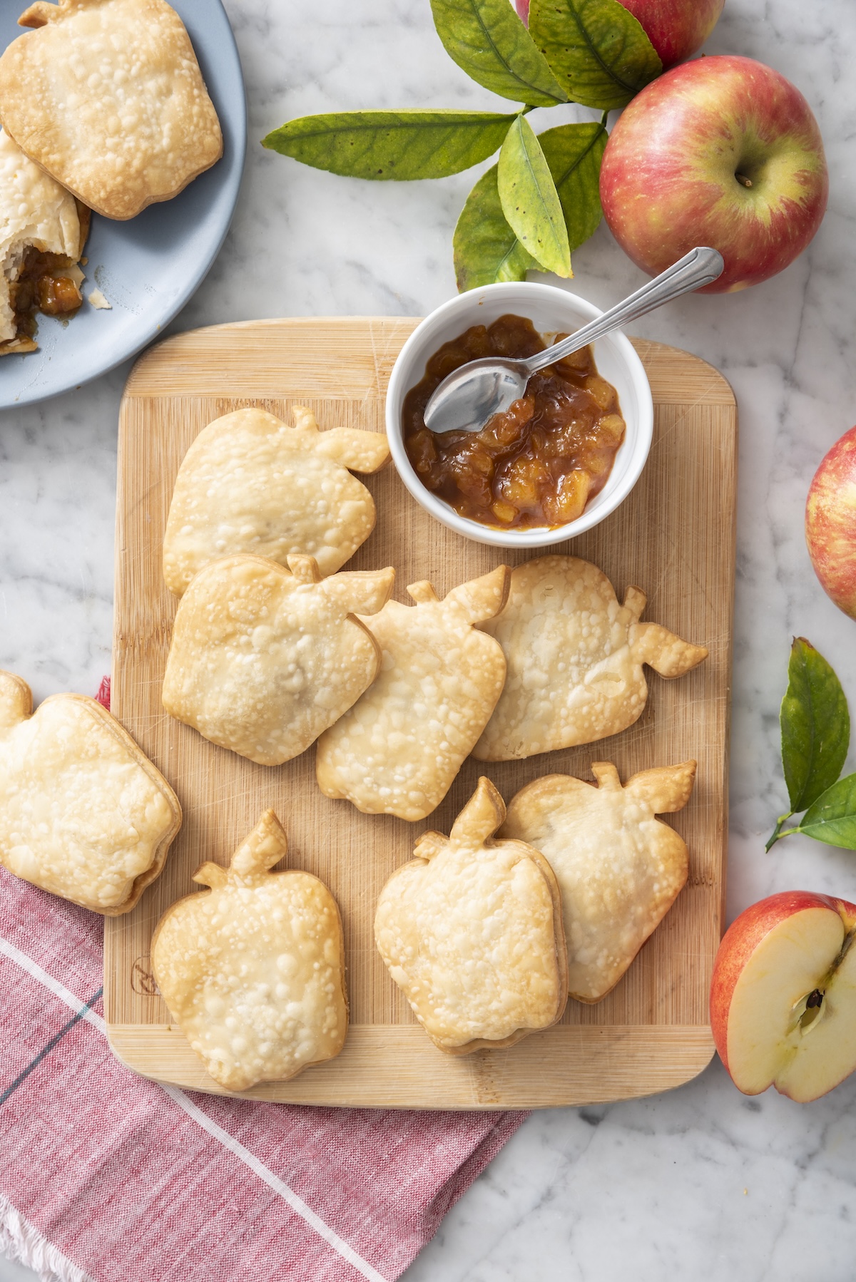 Apple pie turnovers on a serving board.