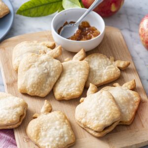 Apple pie turnovers on a serving board.