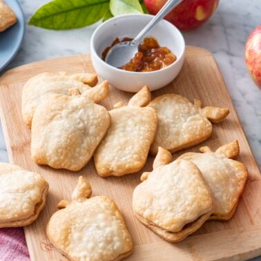 Apple pie turnovers on a serving board.