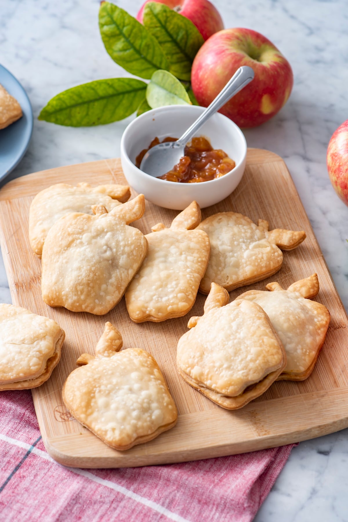 Apple pie turnovers on a serving board.