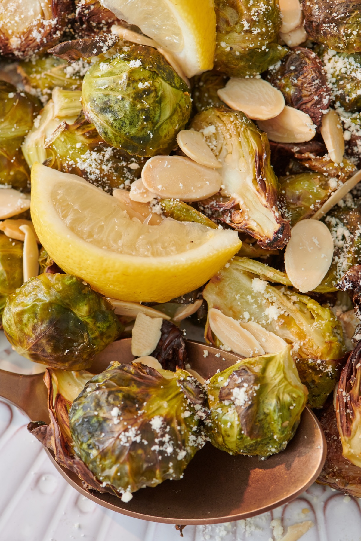 Lemon wedge on a bed of roasted Brussels sprouts.