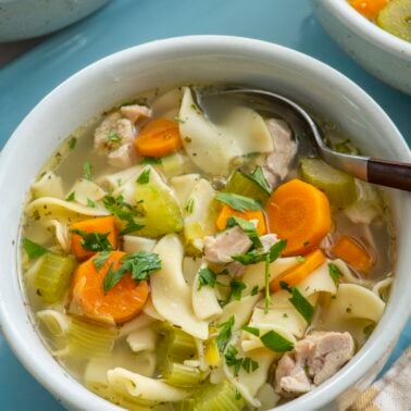 A warm bowl of chicken noodle soup.