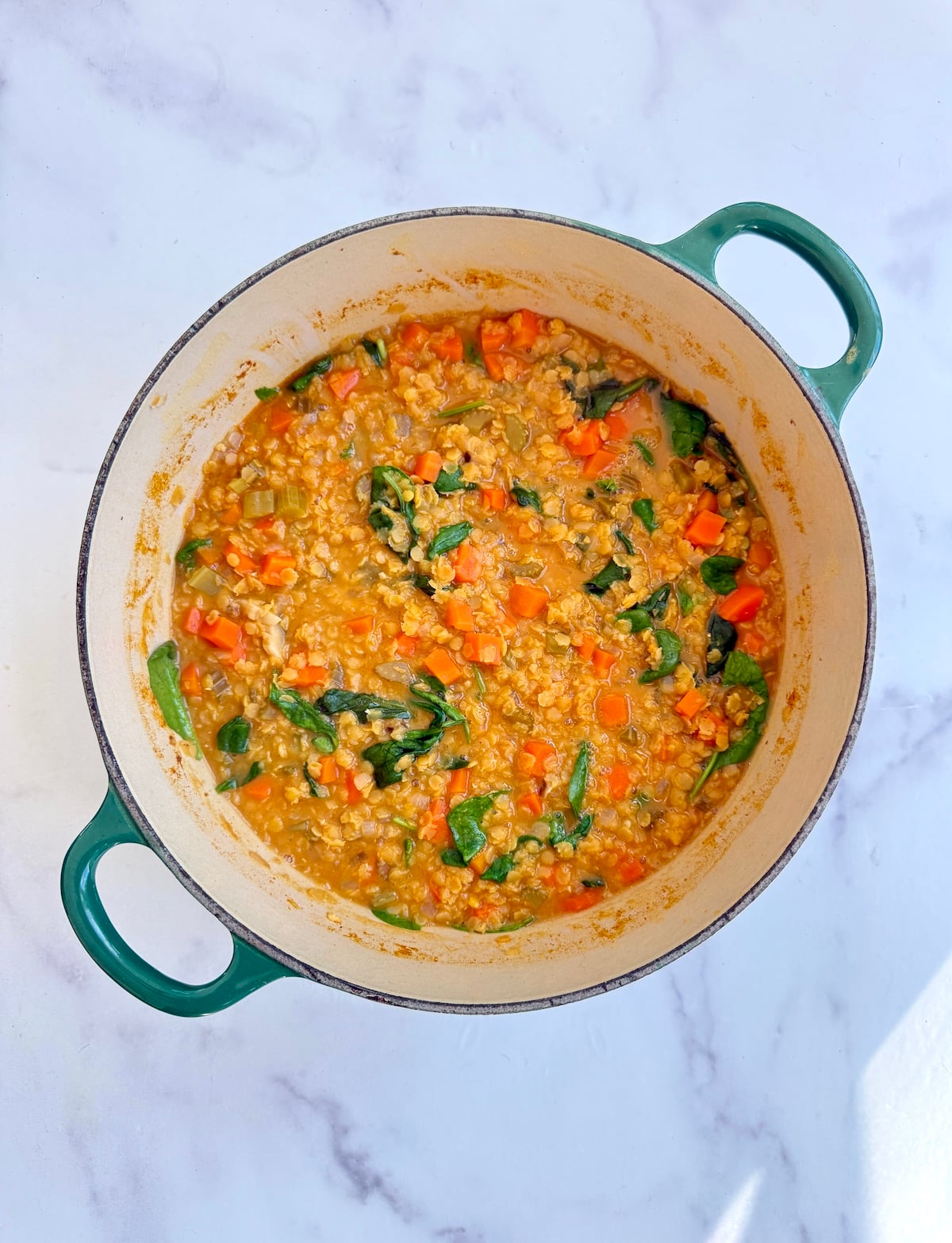 Smoky red lentil stew in a pot.