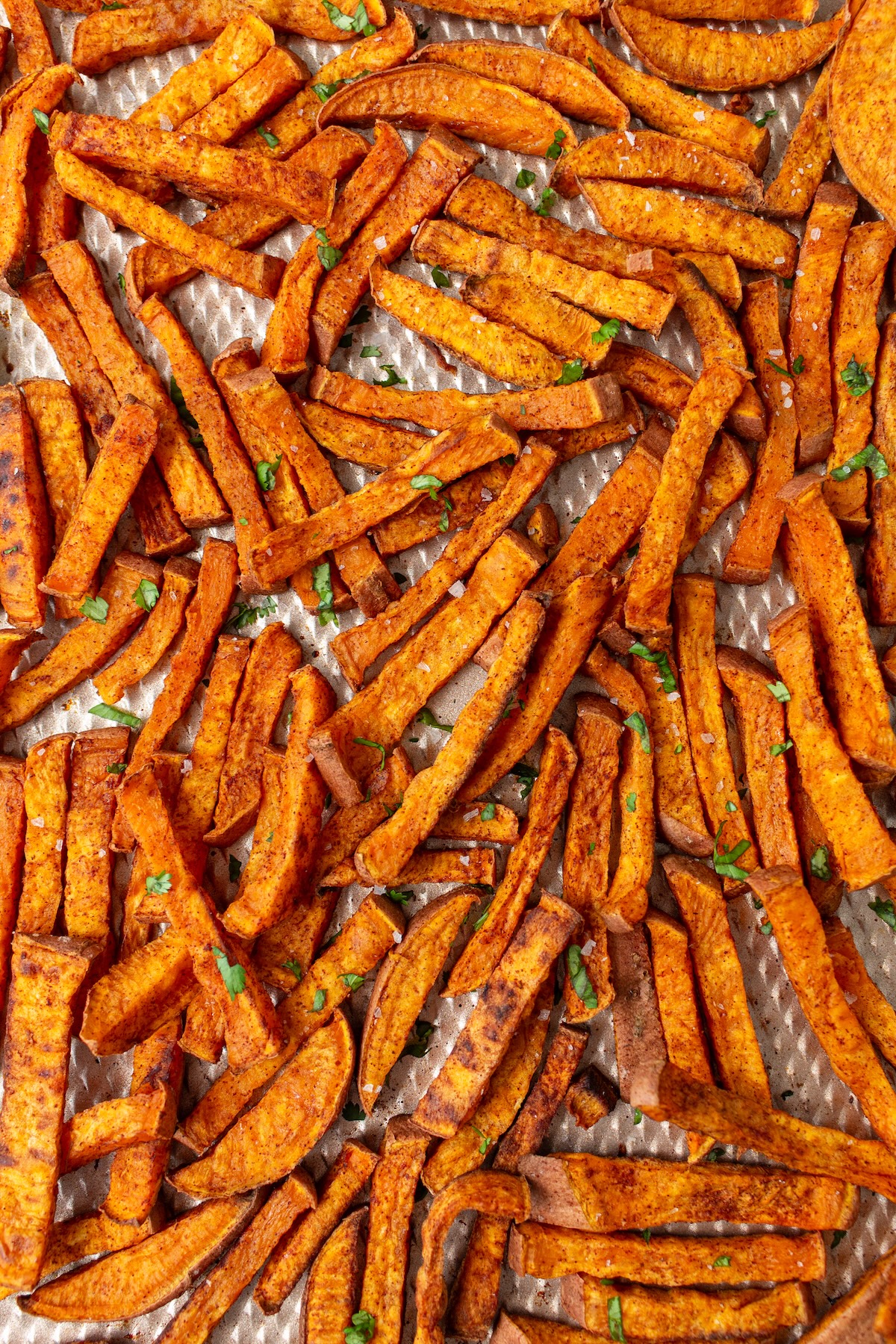 Baked sweet potato fries on a baking sheet.