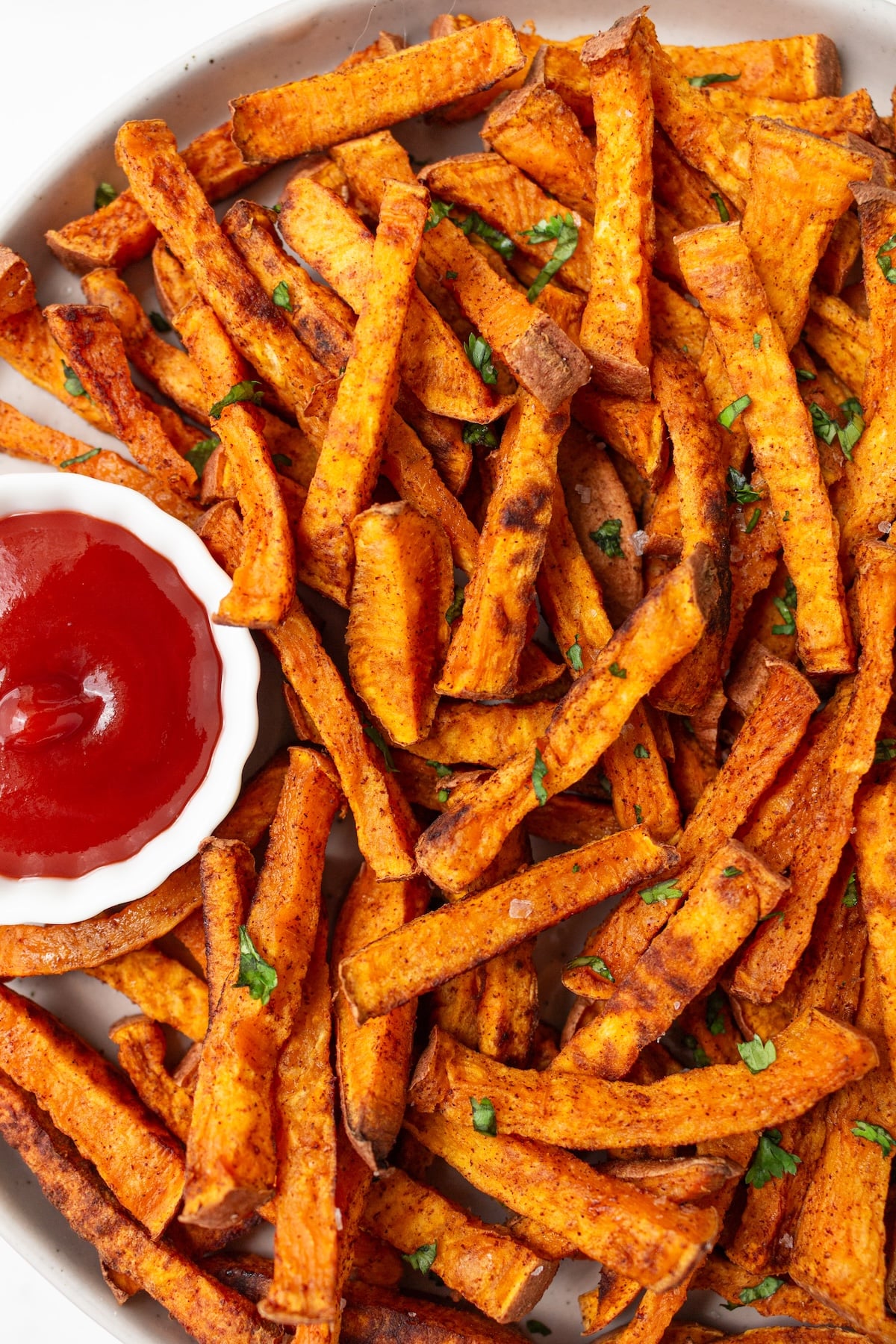 Sweet potato fries served with ketchup.