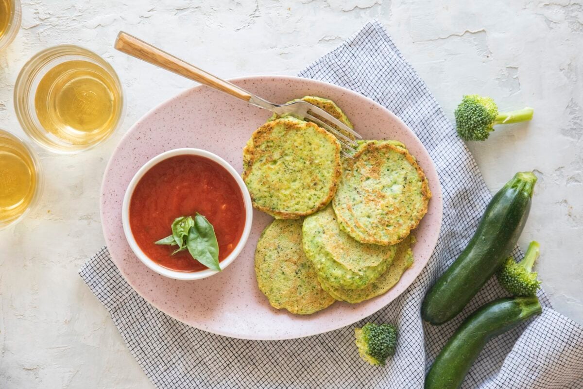 Green veggie pancakes on a white plate.