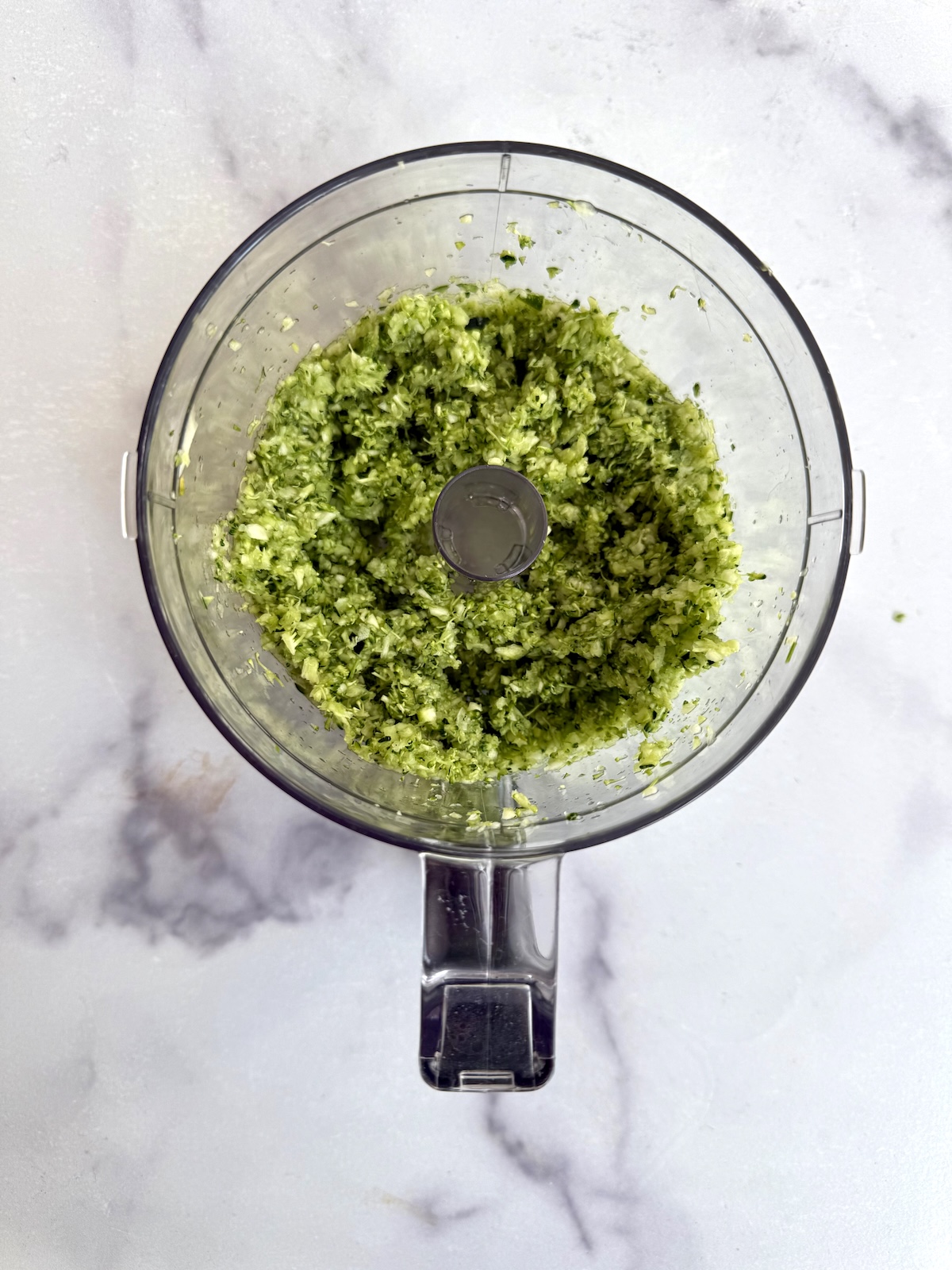Pureed broccoli and zucchini in a food processor.