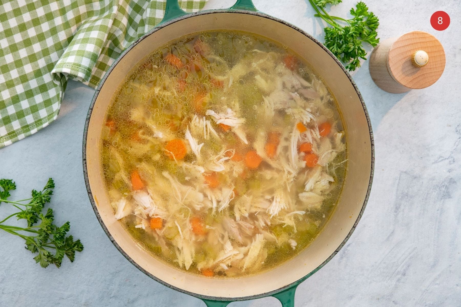 Chicken soup in a soup pot.
