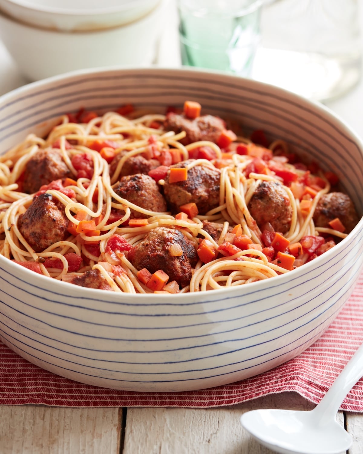 Spaghetti with turkey meatballs in a white bowl.