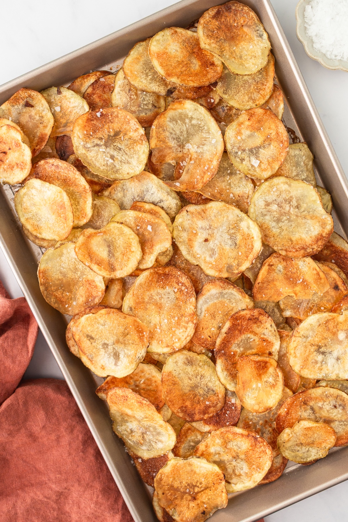 Baked potato chips on a sheet tray.