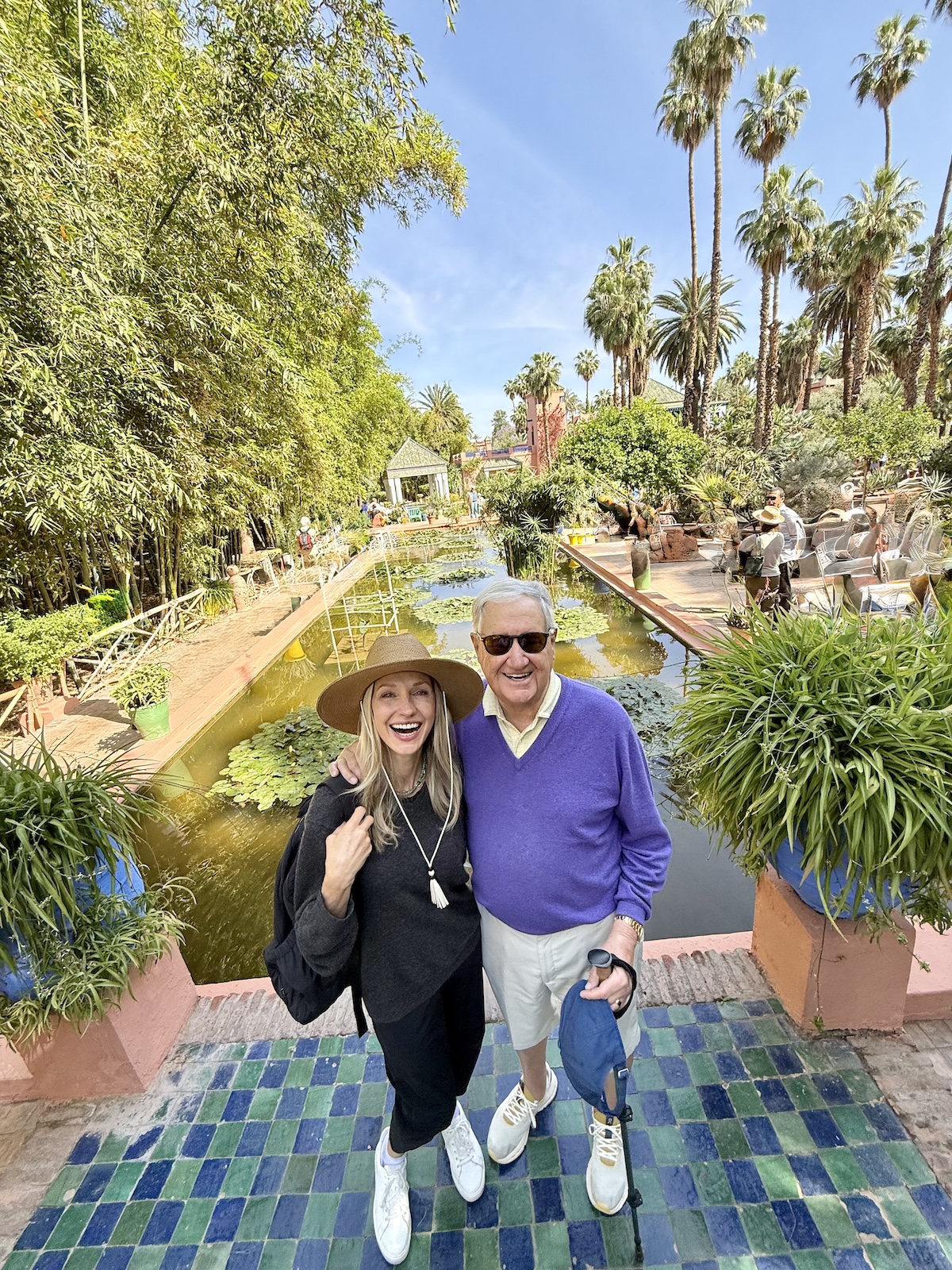 The lush garden paths of Selman Marrakech lined with rose and olive trees.
